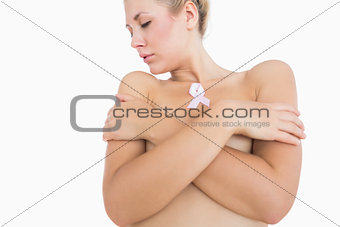 Naked woman with breast cancer ribbon