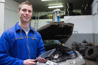 Male mechanic with digital tablet at garage
