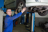 Auto mechanic adjusting car tire