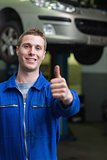 Happy car mechanic gesturing thumbs up
