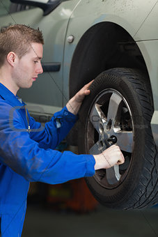 Mechanic changing car tyre
