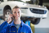 Car mechanic using mobile phone