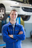 Confident male mechanic smiling