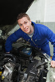 Male mechanic repairing car