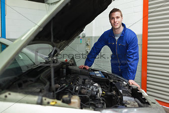 Repairman standing by car with open hood