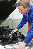 Mechanic checking car engine oil