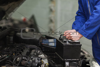 Mechanic changing car battery