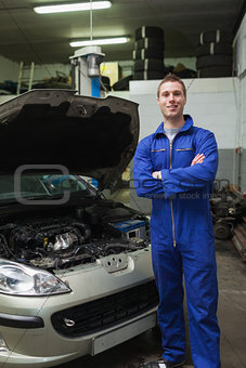 Happy mechanic by breakdown car