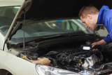 Mechanic repairing car engine