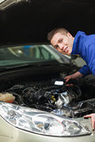 Repairman examining car engine