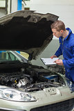 Mechanic checking car engine