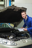 Auto mechanic inspecting car