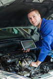 Happy mechanic with digital tablet