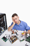 Portrait of tired computer engineer with cpu parts