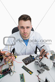 Portrait of confused computer engineer with cpu parts