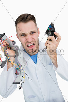 Portrait of young it professional yelling with cpu parts in hands