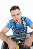 Portrait of tired it professional with cables around neck