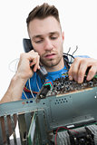 Computer engineer working on sound card on cpu while on call
