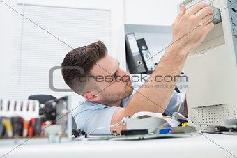 Young it professional repairing cpu on desk