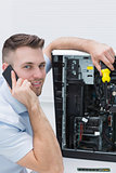 Portrait of computer engineer working on cpu while on call