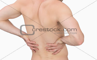 Rear view of muscular man with backache