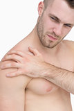 Closeup of shirtless man with shoulder pain