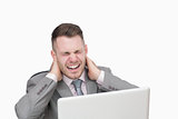 Business man suffering from severe neck pain while using laptop