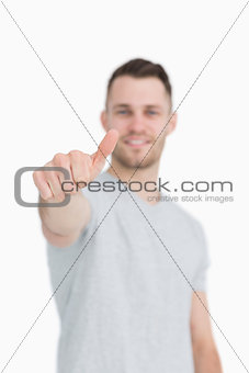 Casual young man gesturing thumbs up
