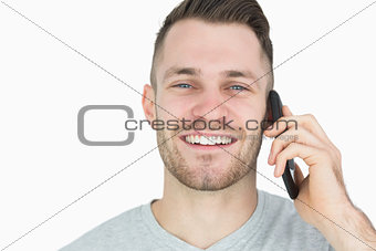 Closeup portrait of young man using mobile phone