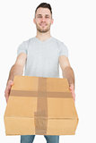Portrait of young man giving you a package box