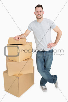 Portrait of smiling young man with cardboard boxes