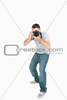 Young male photographer with photographic camera