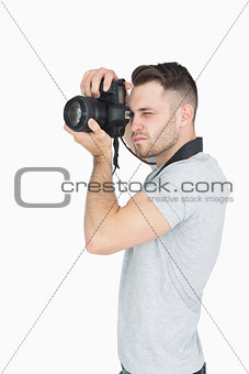 Side view of photographer with photographic camera