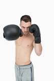 Portrait of young male boxer punching
