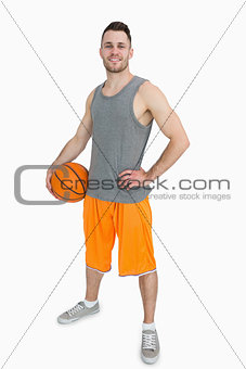 Portrait of happy young man with basketball