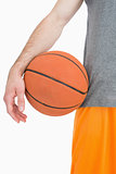 Closeup midsection of man with basketball