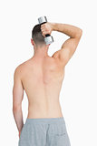Rear view of young man exercising with dumbbell