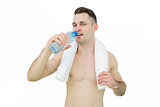 Portrait of young man drinking water with towel around neck