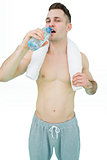 Portrait of man drinking water with towel around neck