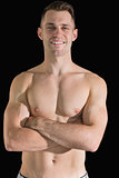 Portrait of bare chested young man with arms crossed