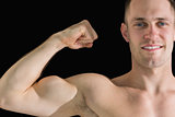 Closeup portrait of young man flexing muscles
