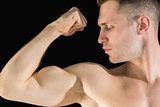 Closeup of young man flexing muscles