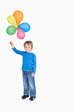 Portrait of young boy holding a bundle of balloons