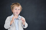Boy dressed as teacher in front of black board