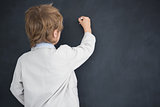 Boy dressed as teacher writes on black board