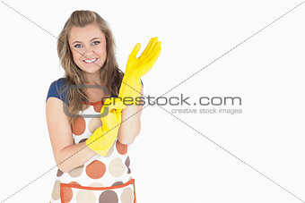 Portrait of smiling young maid with rubber gloves