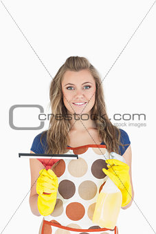 Young maid with wiper and disinfectant spray