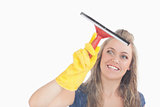 Young maid in yellow gloves using wiper