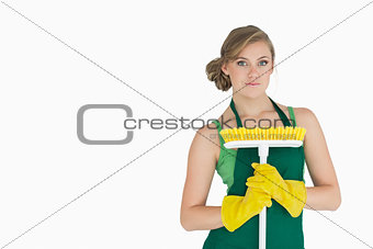 Portrait of young woman with broom