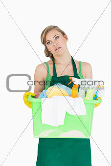 Tied young maid carrying cleaning supplies